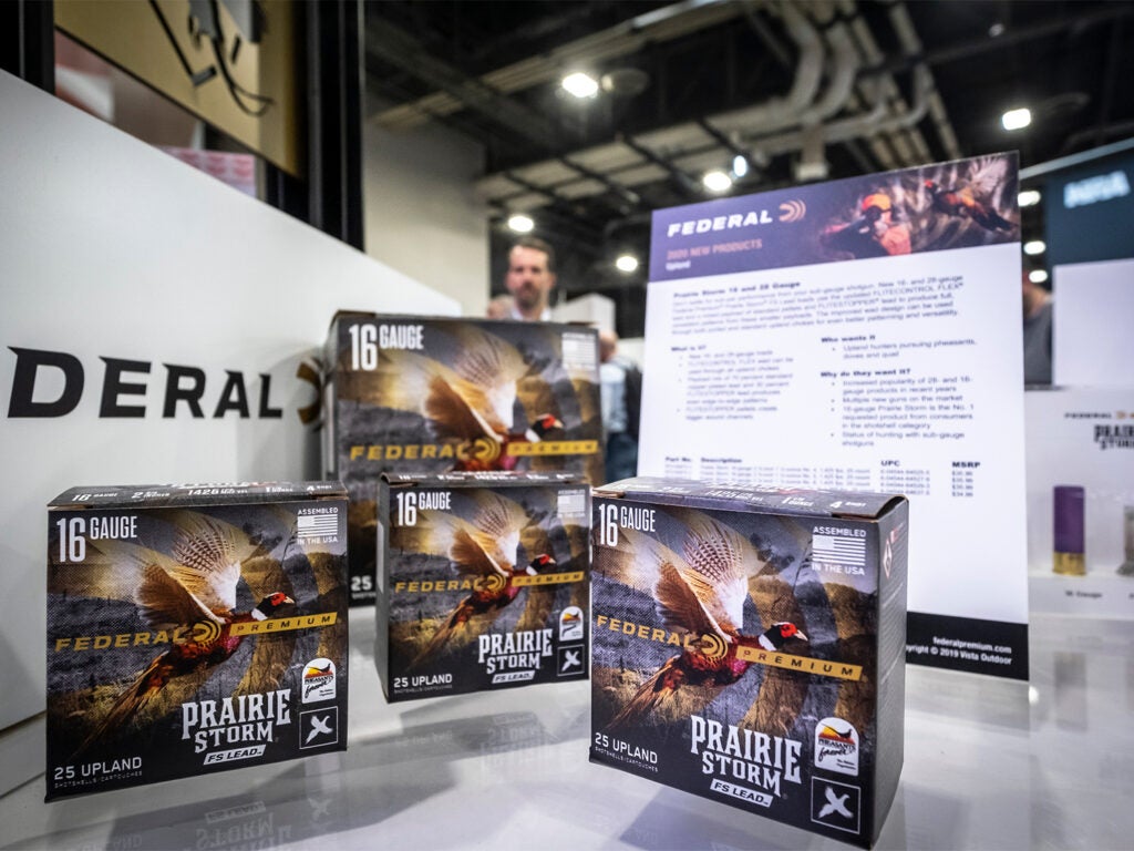 Boxes of Federal Premium ammo stacked on tables at the SHOT Show convention.