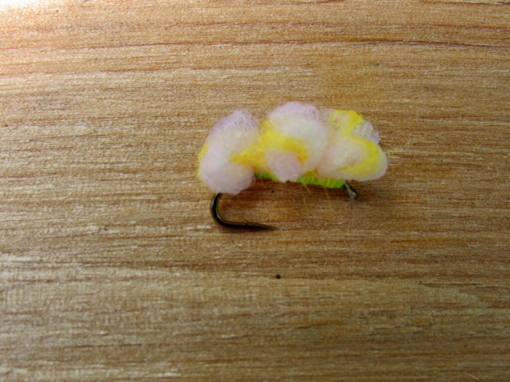 The Three Loop Pink Lady Egg fly lure on a table.