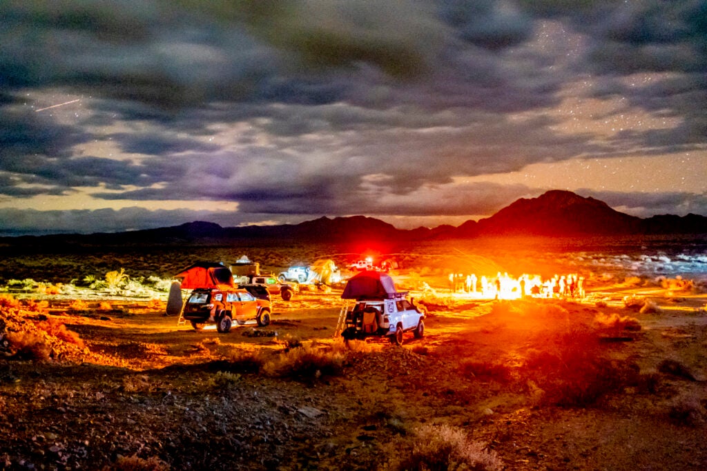 campsite with vehicles at nighttime in the desert.