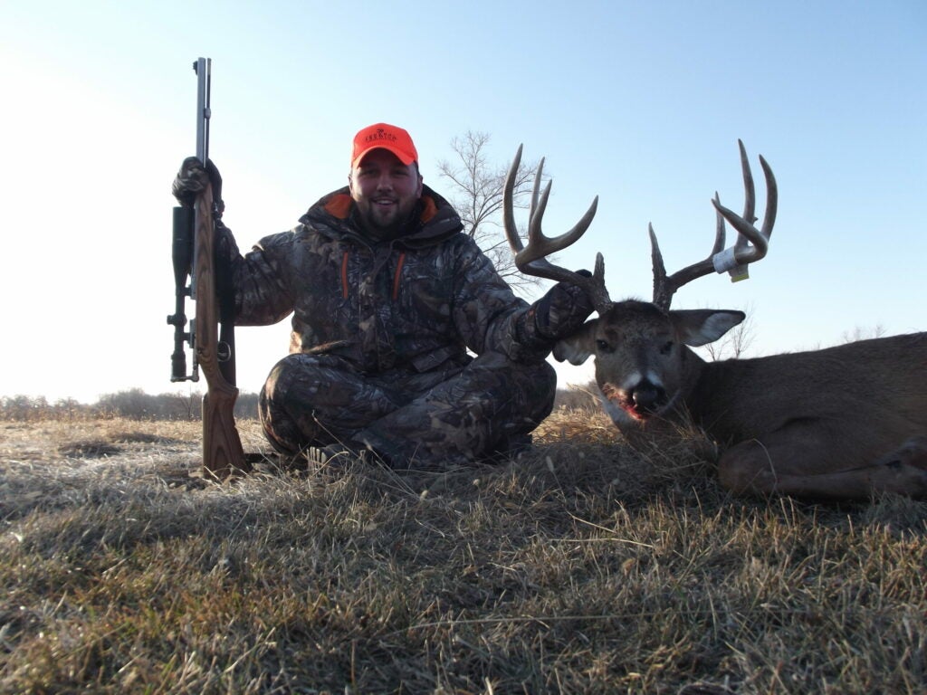 Hunter with a big whitetail buck during the Iowa muzzleloader season.