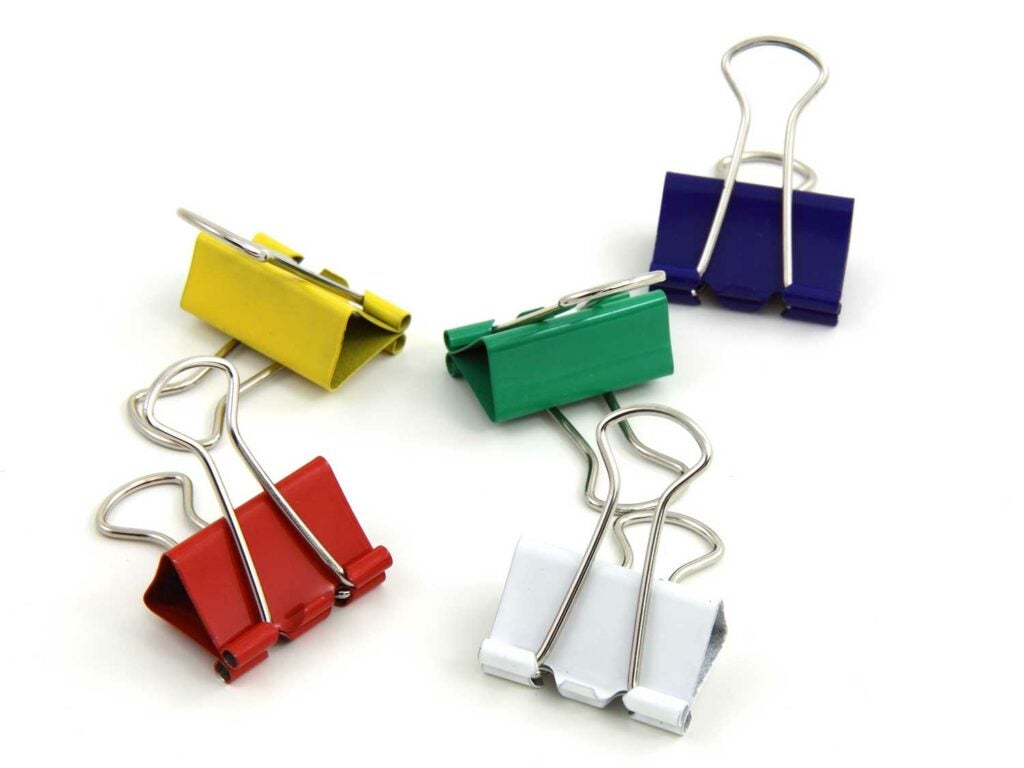 Five binder clips on a white background.