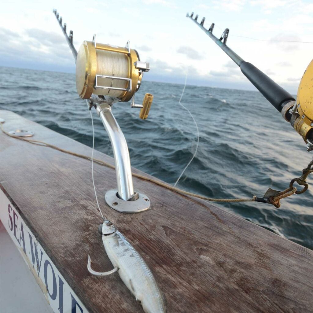 Two fishing reels on a boat deck.