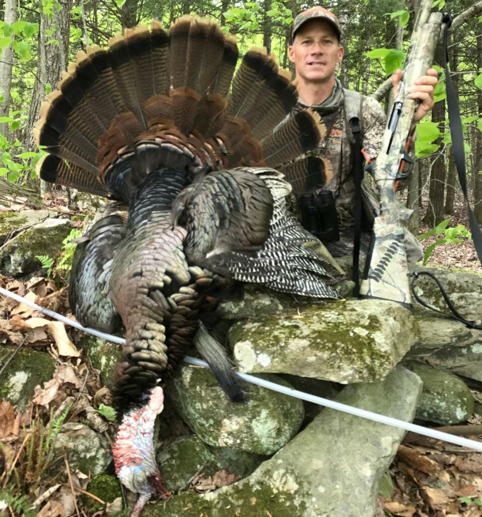 A hunter next to a large public land turkey.