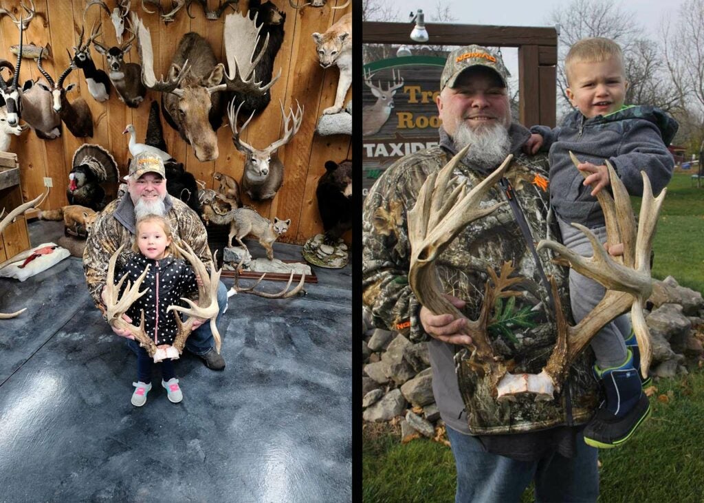 A hunter and his kid show off the deer antlers.