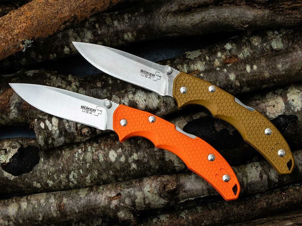 Two knives on a pile of sticks.