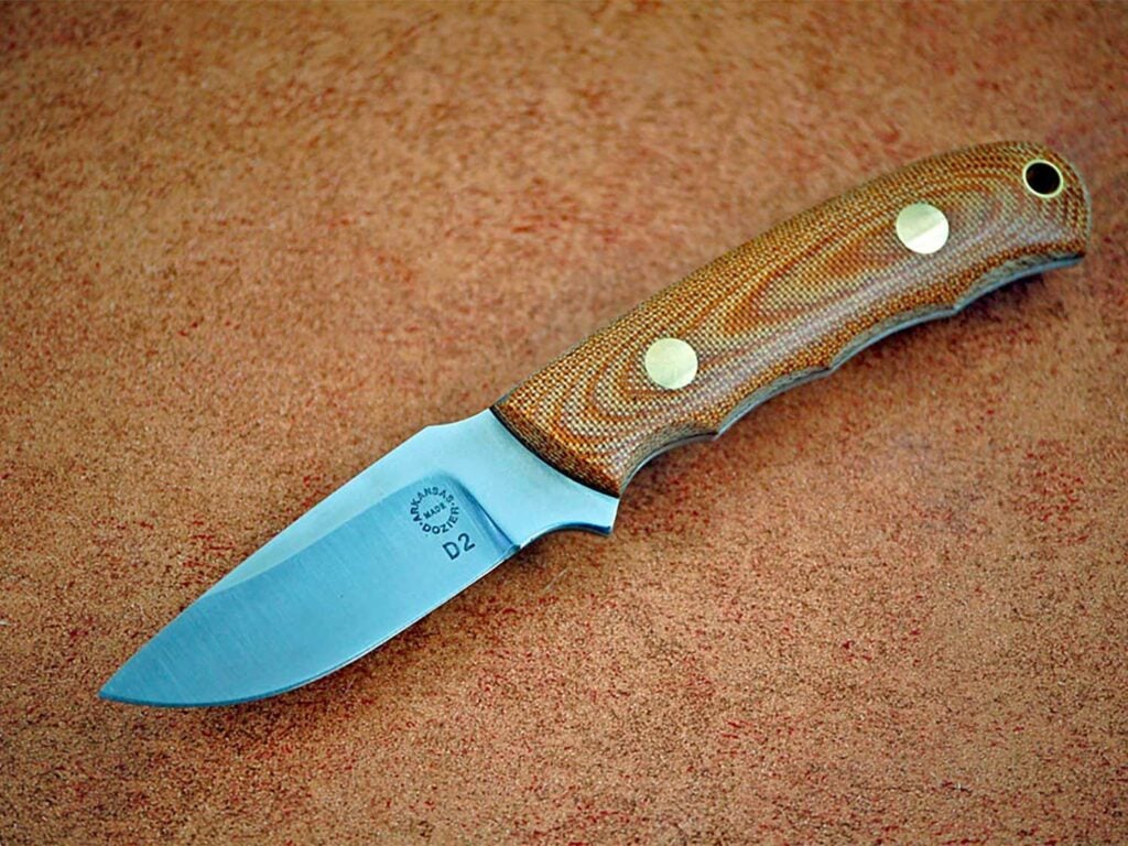A knife on a brown background.
